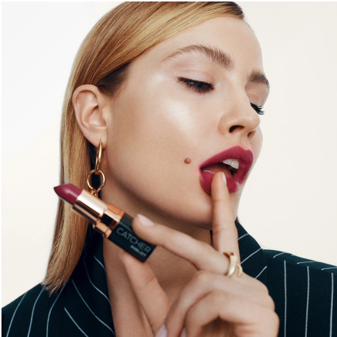 Woman holding red inglot lipstick